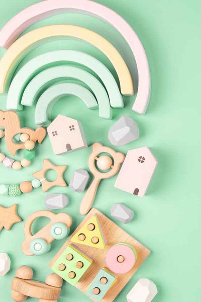 Wooden Baby Toys and Wooden Teethers on a Mint Colored Background