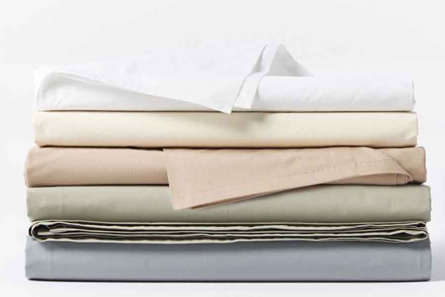 Variety of colored sheets stacked on top of each other with white background
