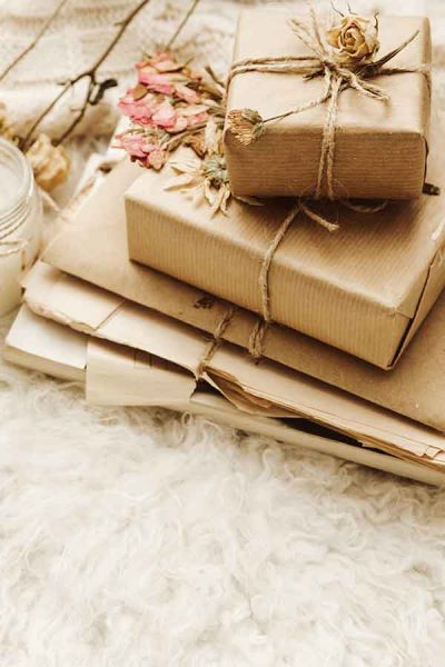 Paper wrapped gifts on a fuzzy white throw