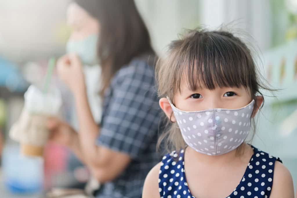 little girl with organic face mask on 