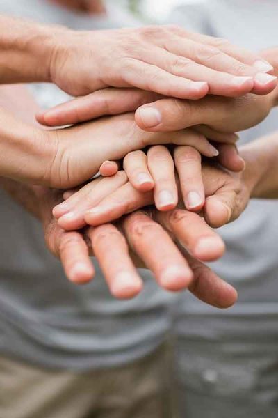 Hands stacked on top of each other in a group