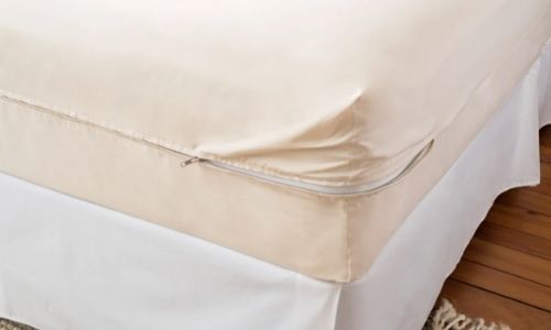 natural colored organic waterproof mattress protector on a bed 