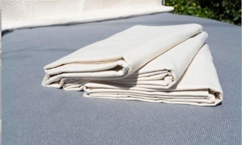 organic cotton mattress protectors sitting on a grey sheet