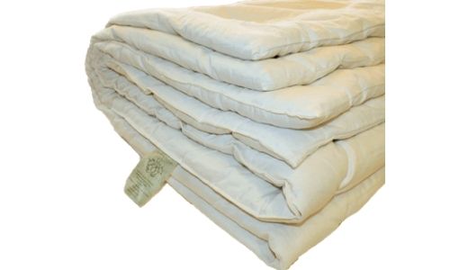 a folded natural colored organic wool comforter