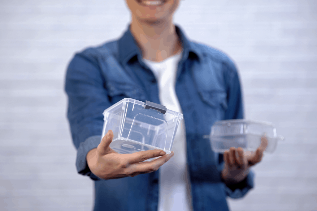 woman in blue shirt holding two clear plastic containers