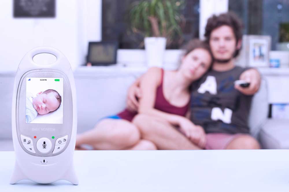 Low EMF Baby Monitors with Couple watching TV in the background