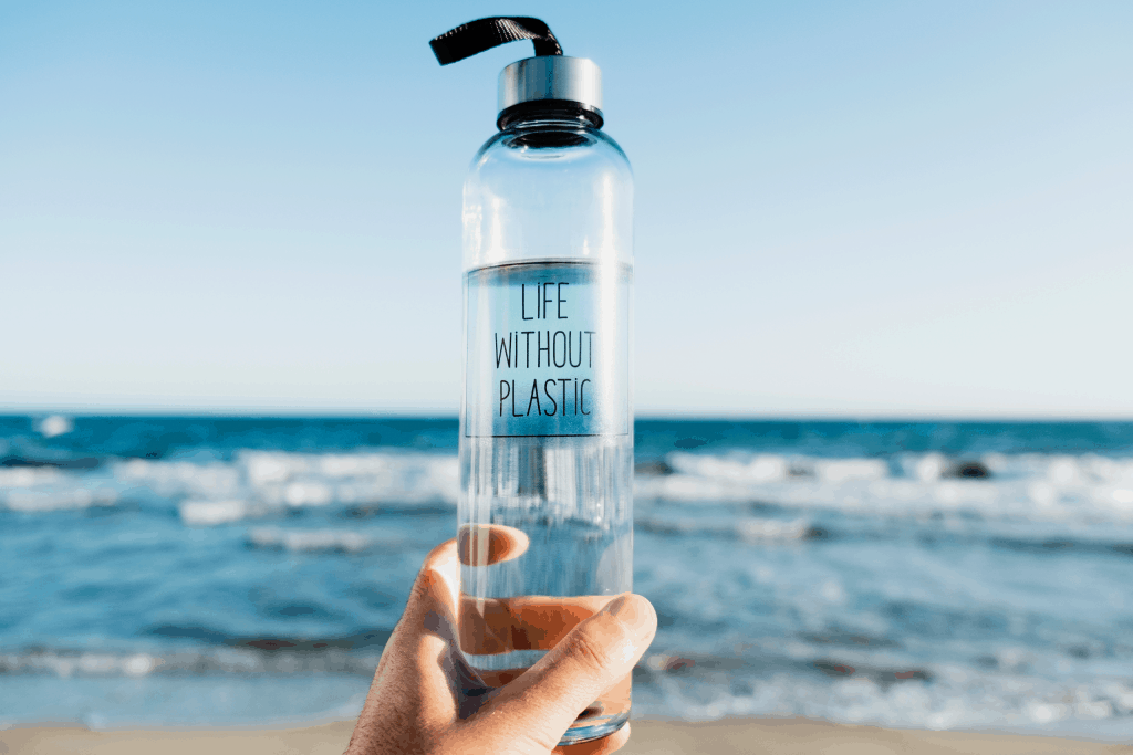 Glass water bottle with text saying "Life without Plastic" with Ocean in the Background