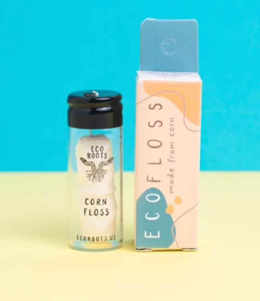 EcoRoots Vegan Eco-Friendly Floss, dental floss in glass container with cardboard container next to it. 
