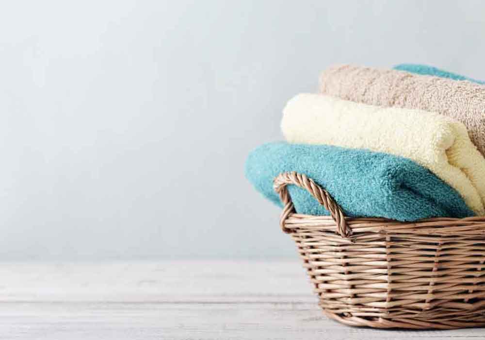 Blue, yellow, and brown organic towels in Woven Basket