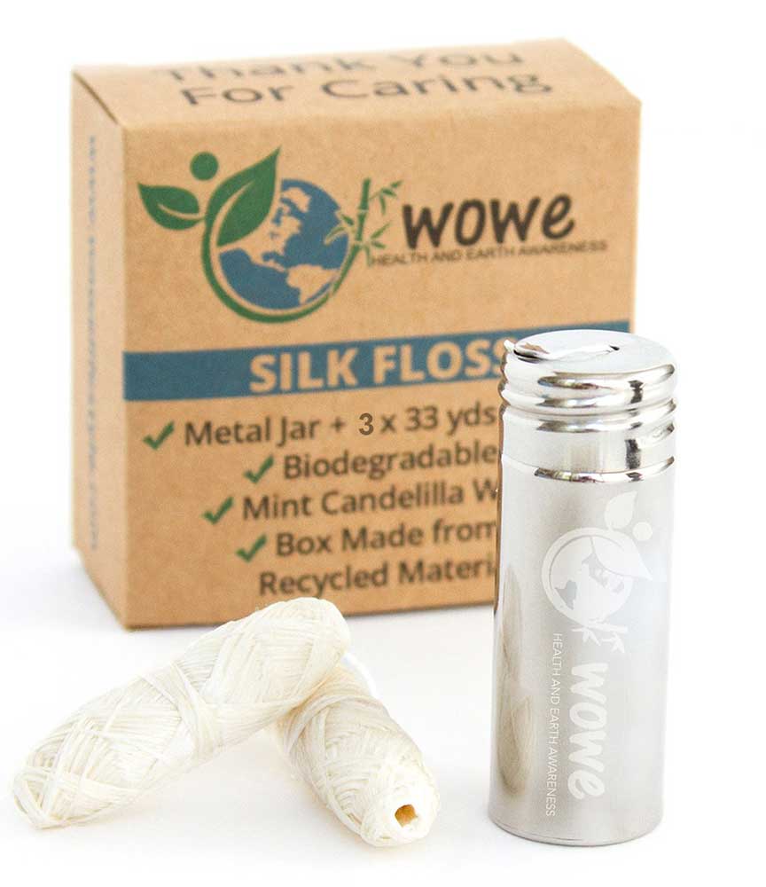 Wowe Natural Biodegradable Silk Floss, floss on table with stainless floss container and cardboard floss box behind 