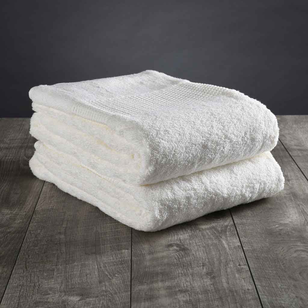 Delilah Home Towels - two white towels folded up on top of each other
