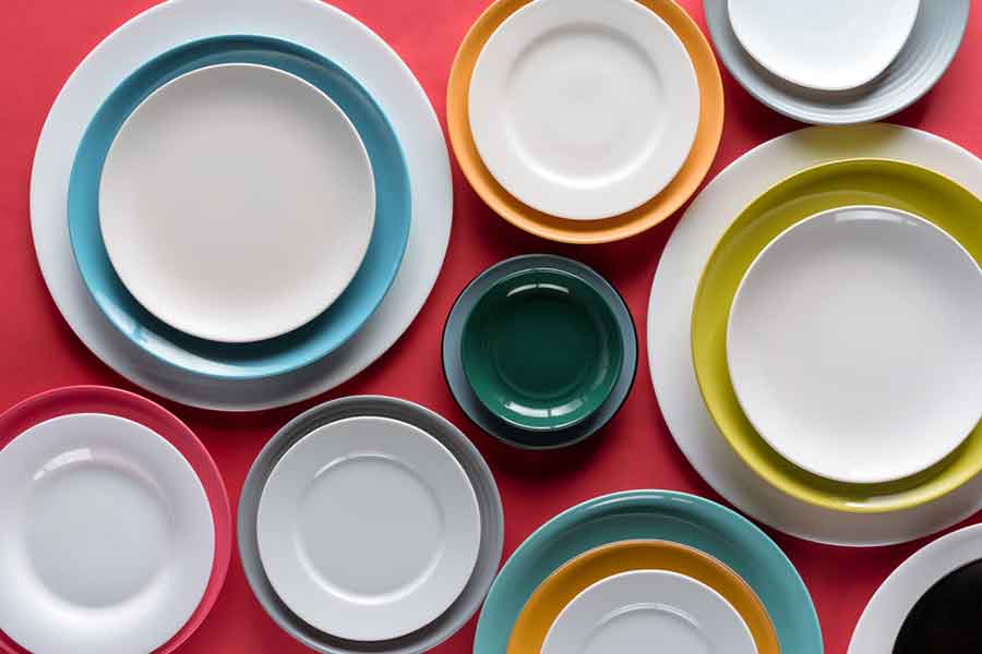 Several colorful stacked plates on a red surface 
