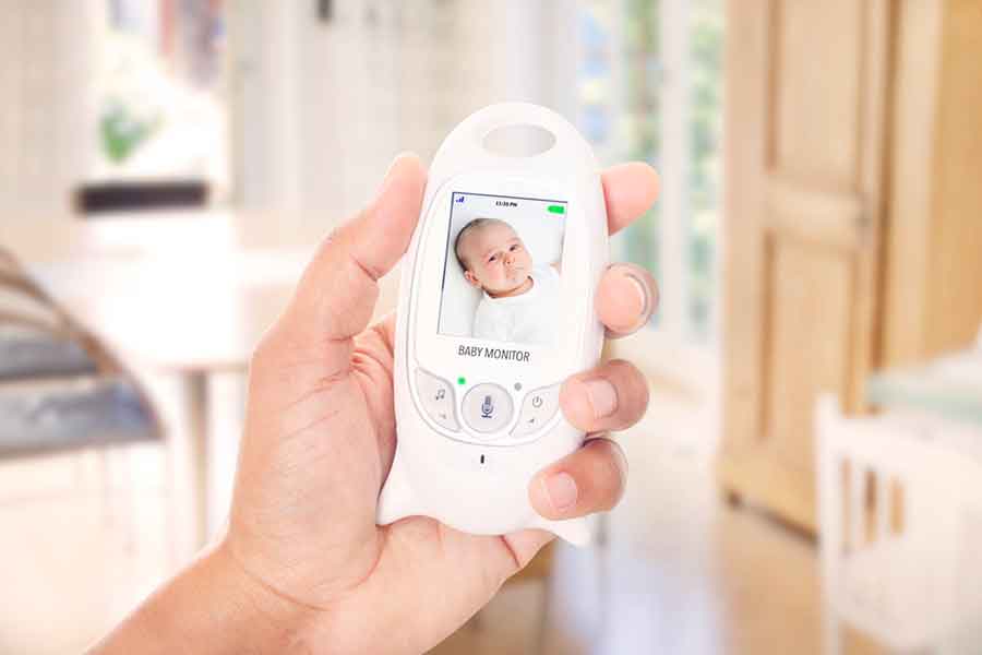 Low EMF Digital Baby Monitors held up inside a kitchen