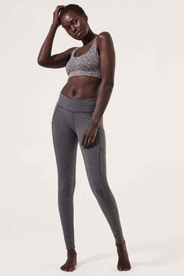 Woman wearing grey sports bra and leggings