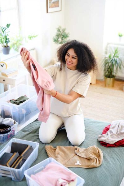 Slow Fashion Featured Image - Woman examining her clothes