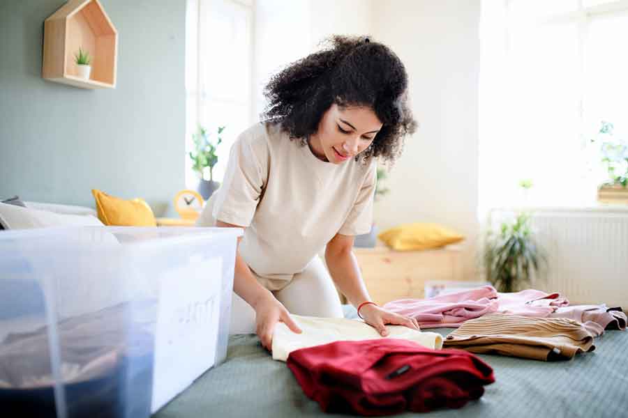 Slow Fashion Featured Image - Woman folding her clothes